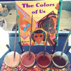 the colors of us are on display in front of a book and some spoons