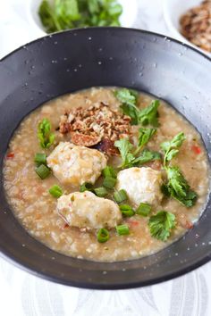 a black bowl filled with food on top of a table