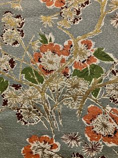 an old rug with flowers and leaves on it