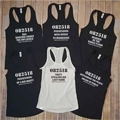 four women's black and white tank tops with numbers on the front, two are shown