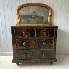 an old dresser with a mirror on top