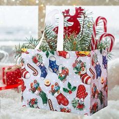 a christmas shopping bag sitting on top of snow covered ground