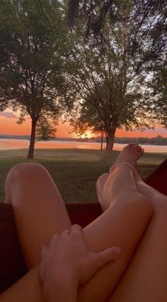 a person laying on top of a hammock with their feet up in the air