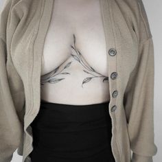 a woman's chest with leaves on it and the bottom part of her body