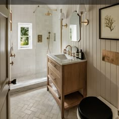 a bathroom with a toilet, sink and mirror