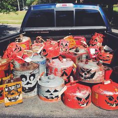 the back of a pick up truck filled with red and black gas canisters