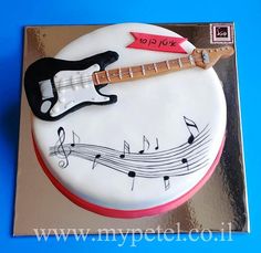 a birthday cake with a guitar and musical notes on it