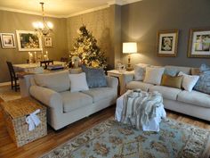 a living room filled with furniture and a christmas tree