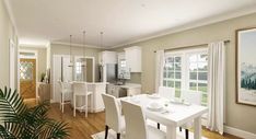 a dining room and kitchen area with white furniture