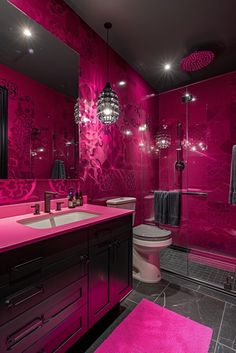 a bathroom with pink walls and flooring in the shower area is decorated with chandeliers