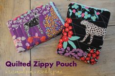 two zippered pouchs sitting next to each other on a wooden floor with the words quilted zippy pouch