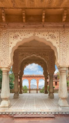 an ornate archway in the middle of a building with pillars and arches on either side