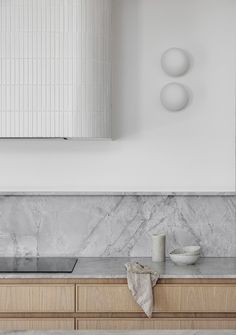 a kitchen with marble counter tops and wooden cabinets