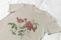 -- Red Rose Definition T Shirt -- A beautiful red rose design printed on a comfortable, soft, and high-quality t-shirt. Whether it's Valentines Day or not, this would make a great gift for her anytime of the year! A one of a kind and original design! Perfect for outdoors, hiking, camping, etc.  -- Creating my designs -- Hey there shoppers! Just a little back story on my products... I've always loved designing anything and everything whether that be paintings, cakes, rooms, decor or clothing prints! I guess you can say this is just another creative outlet for me! All my designs are created by me, using canva, a graphic design program that gives me the creative freedom to come up with all sorts of new prints. I also work with Printify, which is a company that prints my designs onto different Casual Rose Print Tops In Rose Color, Casual Rose Print Tops, Casual Rose Cotton Top, Casual Cotton T-shirt With Rose Print, Rose Color Crew Neck Top With Rose Print, Casual Rose Tops With Rose Design, Rose Definition, Definition Shirt, Wildflower Shirt