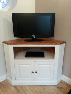 a flat screen tv sitting on top of a white entertainment center