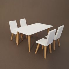 a white table with four chairs around it on a brown floored surface in front of a gray wall