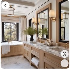 a bathroom with marble counter tops and double sinks