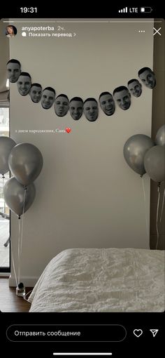 balloons floating in the air next to a bed with pictures on it and an image of a man's face