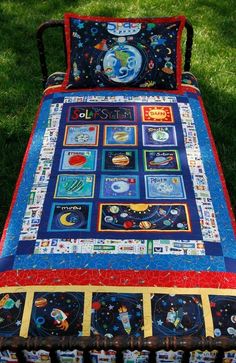 a quilted bed with space themed sheets on it