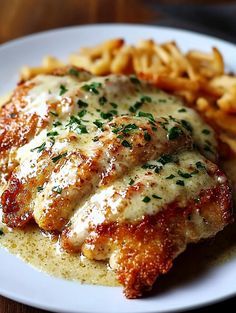 chicken parmesan and french fries on a white plate