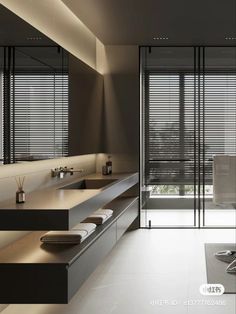 a modern bathroom with two sinks and large mirrors on the wall, along with sliding glass doors