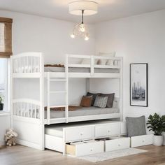 a white bunk bed sitting next to a window