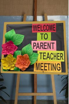 a welcome sign with paper flowers on it for parents and children to come home from school