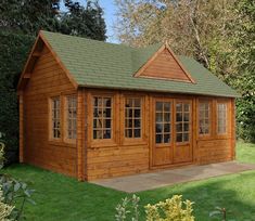 a small wooden building sitting on top of a lush green field