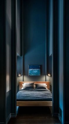 a bedroom with dark blue walls and wooden floors, along with a bed in the middle