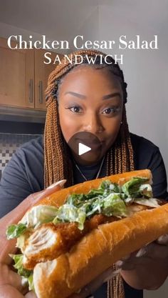 a woman holding a chicken caesar salad sandwich in front of her face with the caption chicken caesar salad sandwich sandwhich