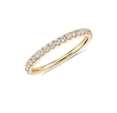 a yellow gold wedding band with white diamonds