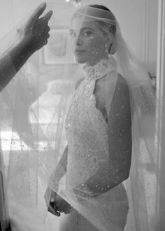 the bride is getting ready to walk down the aisle in her wedding dress and veil