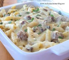 a casserole dish with meatballs and cheese in it on a wooden table