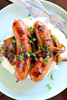 two sausages and mashed potatoes on a plate