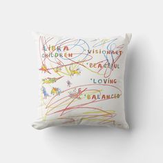 a white pillow with colorful writing on it