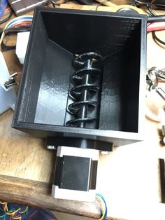 the inside of a black box on top of a table with wires and other items