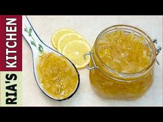 a jar filled with liquid next to sliced lemons