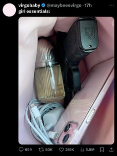 the contents of a cell phone and other electronics in a pink bag, including an electric hair dryer