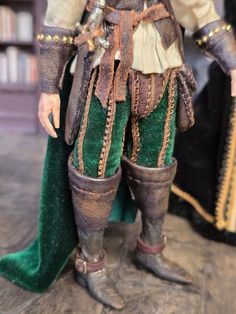 a close up of a figurine of a man in green pants and boots