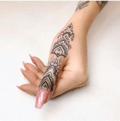 a woman's hand with a tattoo on it