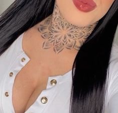 a woman with long black hair wearing a white shirt and tattoos on her neck is looking at the camera