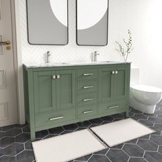 a bathroom with two sinks, mirrors and rugs on the floor in front of it