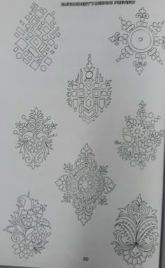 an open book with many designs on it