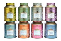 six tins of tea with labels on them