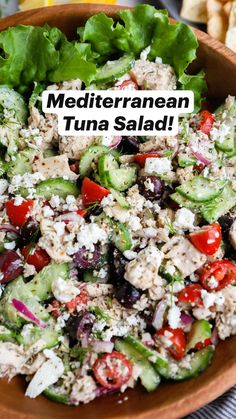 a salad with cucumbers, tomatoes, black olives and feta cheese