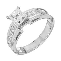 a princess cut diamond ring with channeled shoulders