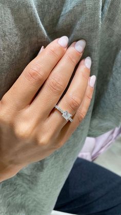 a woman's hand with a diamond ring on it