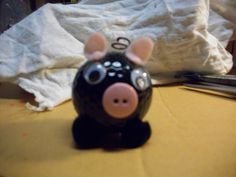 a pig figurine sitting on top of a table