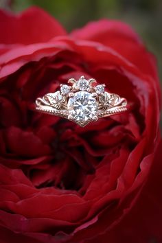 a close up of a rose with a diamond ring on it's center piece