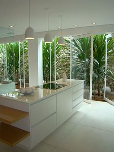 an open kitchen and dining area with sliding glass doors